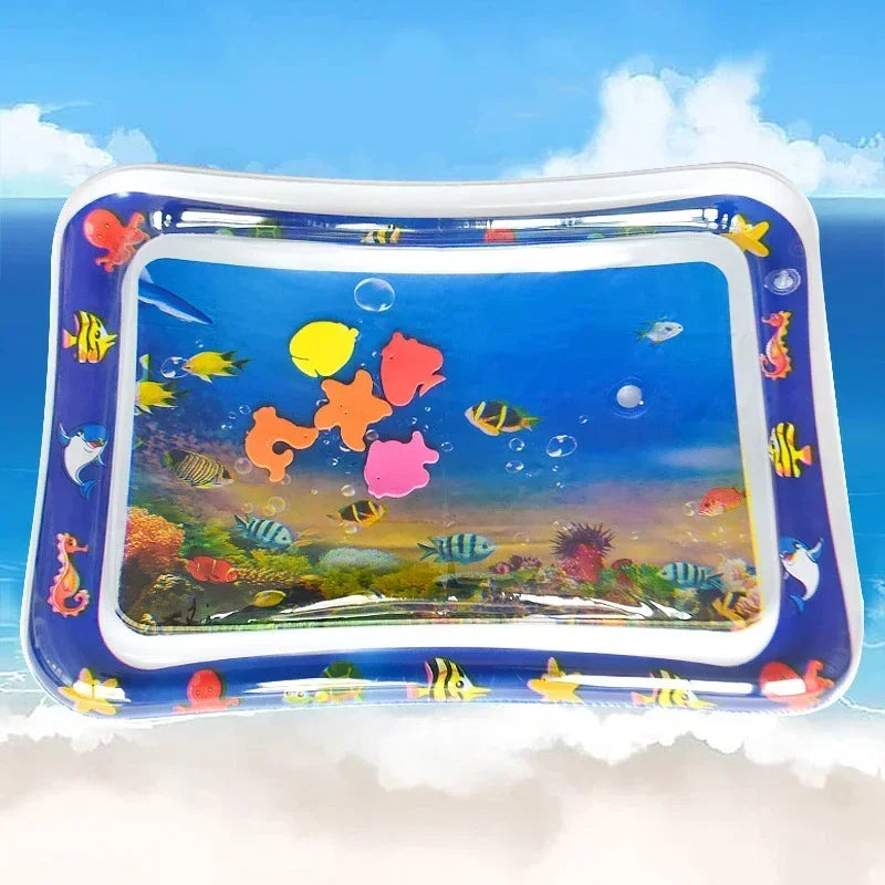Inflatable baby water play mat with colorful fish and sea creatures design, clear water-filled center, and blue border.