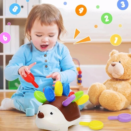 Hedgehog-shaped fine motor toy with brown body and colorful key pieces