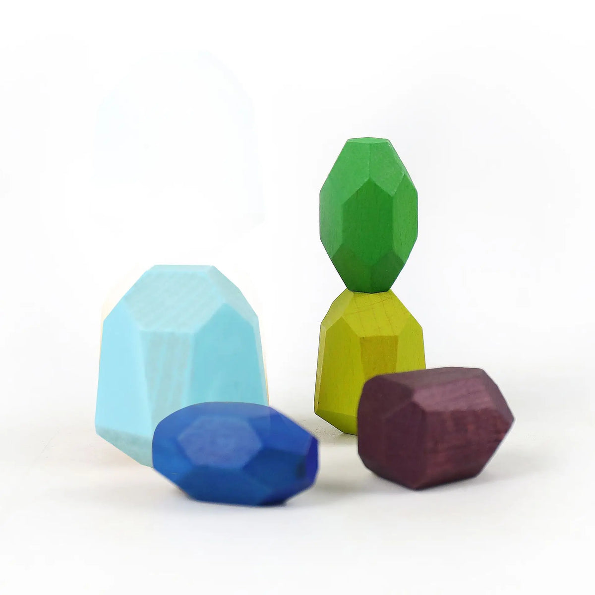 Five colorful wooden stacking rocks in various shapes: blue, green, yellow, purple, and light blue.