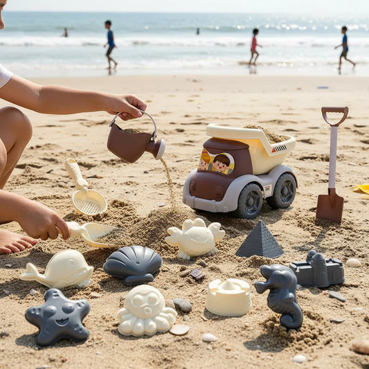 Colorful beach sand toy set including a truck, shovel, and various molds on sandy beach with children playing in the