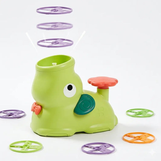 Green elephant flying disc launcher with orange button, four purple and green flying saucers