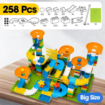 Colorful building blocks arranged in a marble race run with funnels and slides, featuring orange and blue elements.