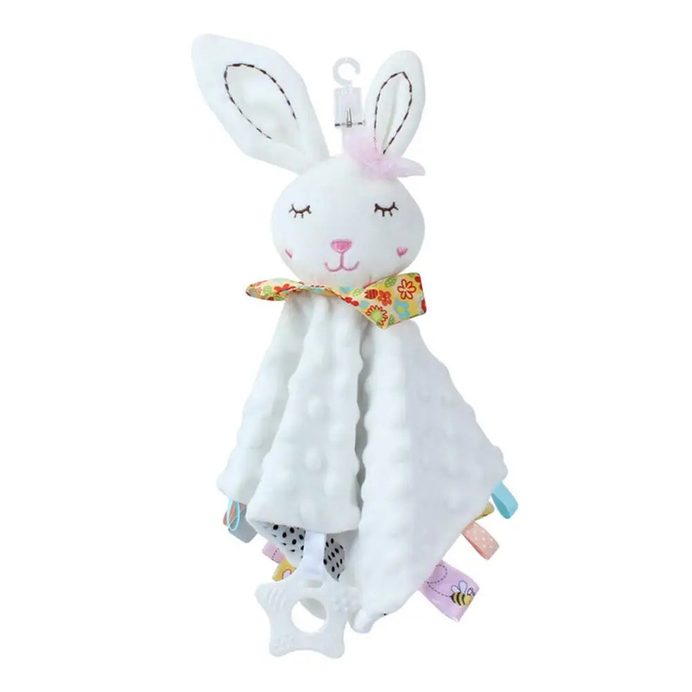 White plush bunny comforter with colorful tags and floral bow, soft texture for infants.