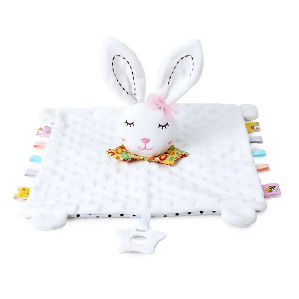 White plush baby comforter with a bunny head, floral collar, and colorful tags on edges, soft texture.