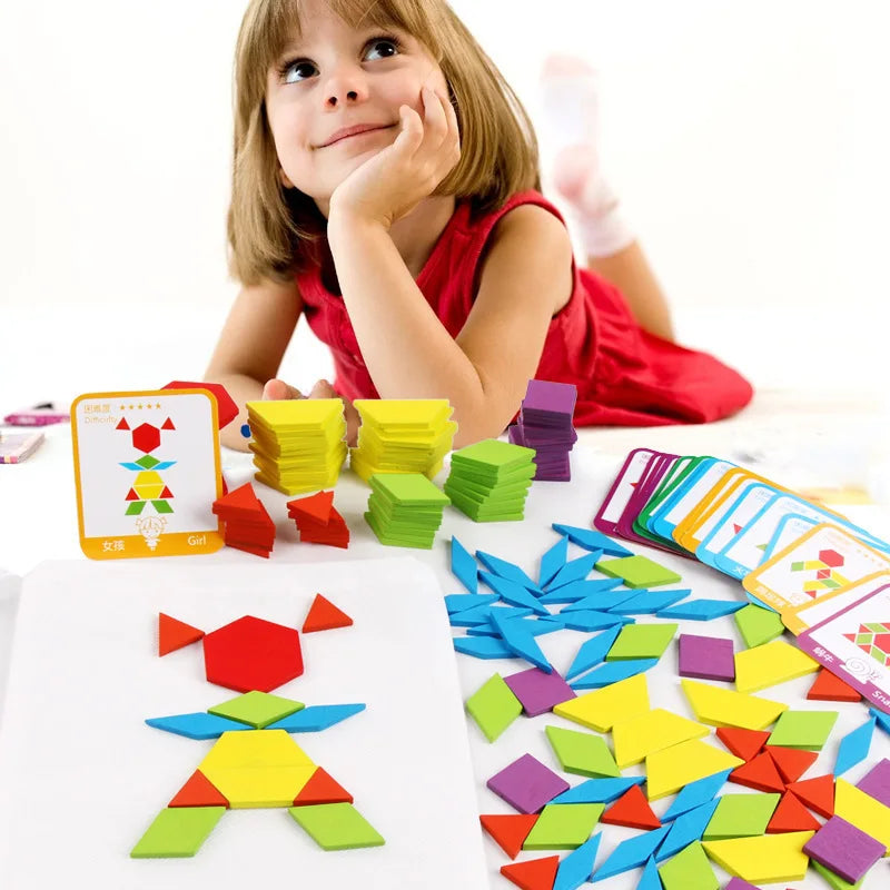 A young girl smiling while playing with colorful wooden geometric pattern blocks, creating shapes on a mat.
