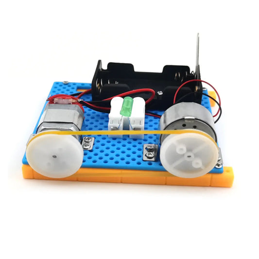 Mini electric generator model with two motors, battery holder, and wires on a blue base, designed for STEM education.