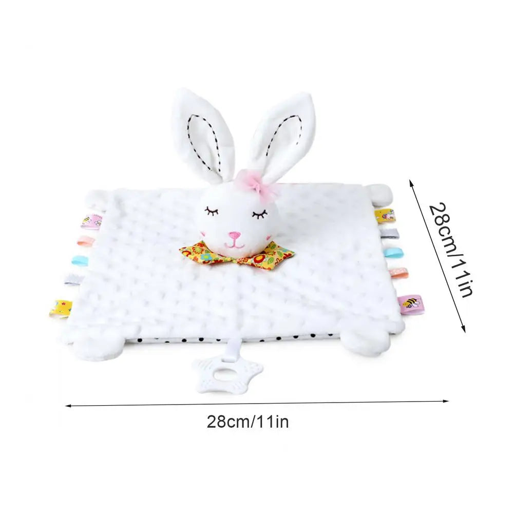 Plush rabbit comforter with a white blanket, featuring colorful tags and a bow tie on the bunny's head.