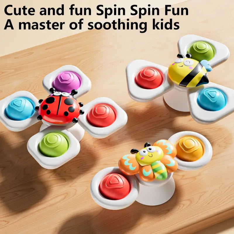 Three colorful suction cup spinning top toys featuring a ladybug, bee, and flower design, ideal for kids.