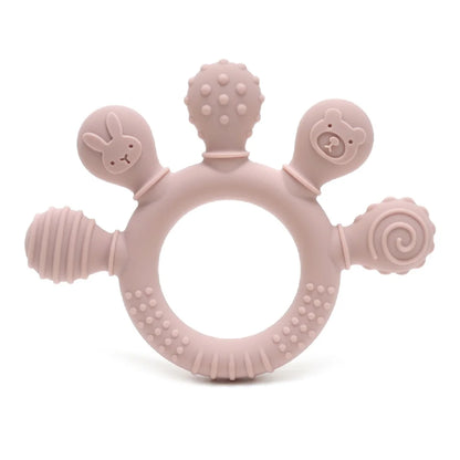 Blush pink silicone baby teether with various textured shapes, including a bunny and bear design, for sensory relief.