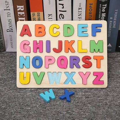 Wooden puzzle board with colorful alphabet letters A-Z and two loose pieces, set on a textured gray surface.