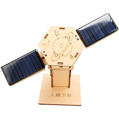 Wooden satellite model with solar panels, featuring a hexagonal base and space-themed engravings.