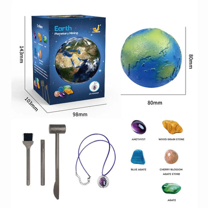 Box featuring Earth planet design, toy digging tools, colorful gems, and a necklace with a gem pendant.