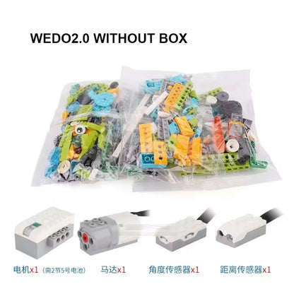 WeDo 2.0 robotics kit components in clear bags, including motors, sensors, and colorful building blocks.