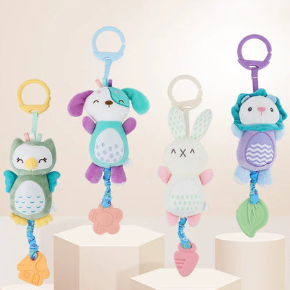 Four colorful soft stuffed animal rattles with hand grips, featuring an owl, a dog, a bunny, and a lion design.