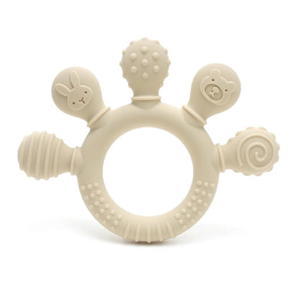 Beige silicone baby teether with various textures and shapes, including a bunny and bear design, for sensory relief.