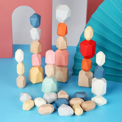 Colorful wooden stacking rocks in various shapes and sizes, arranged with some loose pieces on a blue surface.