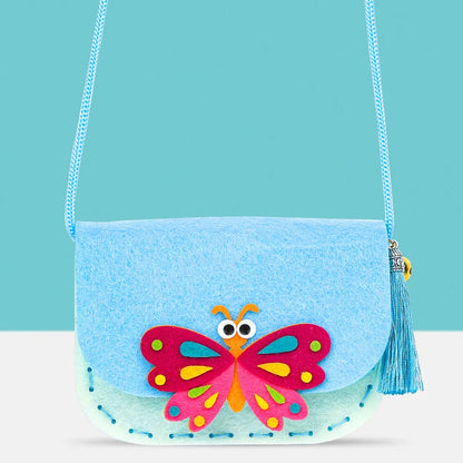 Colorful butterfly design on a blue felt crossbody purse with a tassel and a light blue strap