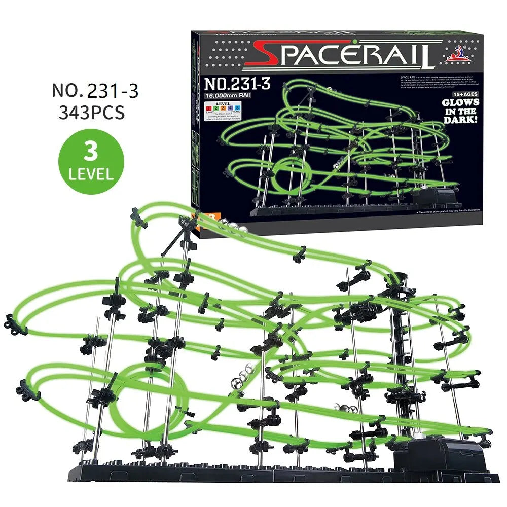 Luminous marble run maze with green tracks and black supports, featuring a box labeled 'Spacerail' and '3 LEVEL'.