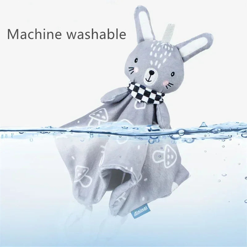 Plush bunny toy with a gray body, checkered scarf, and long ears, partially submerged in water, labeled machine washable.