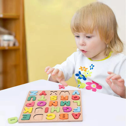 A toddler playing with a colorful wooden alphabet puzzle on a table, focused on matching letters.