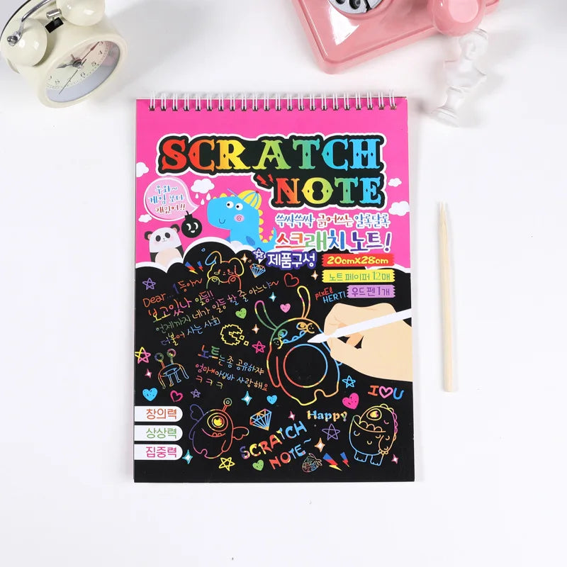 Pink scratch note pad with colorful designs, featuring cartoon characters and a pencil, ideal for kids' art projects.