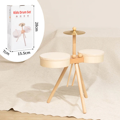 Wooden kids drum set with two white drum pads, a cymbal, and a light wood tripod stand.