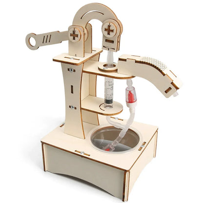 Hand water pump toy made of light wood with a transparent tube and a container base for educational experiments.