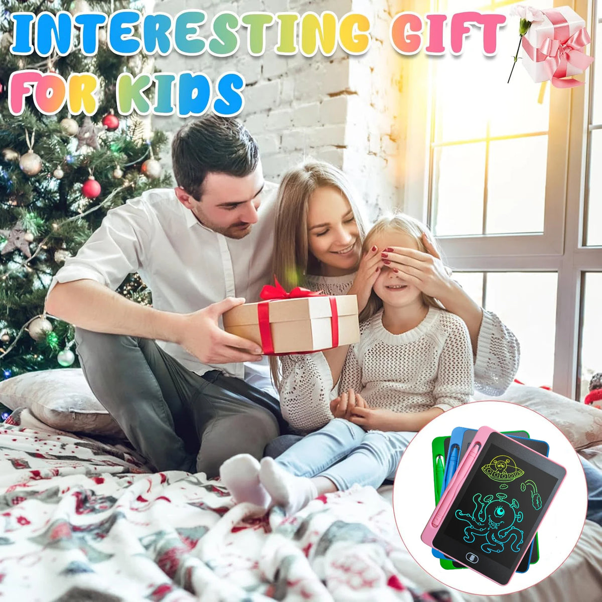 A family sitting on a cozy floor, a man holding a gift box while a woman covers a child's eyes. Colorful LCD writing tablets