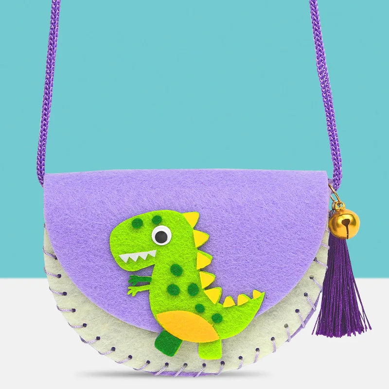 Dinosaur-themed crossbody purse in purple and green felt with a tassel and bell detail