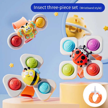 Three colorful suction cup spinning top toys shaped like insects, featuring a bee and ladybug, with a watch band.