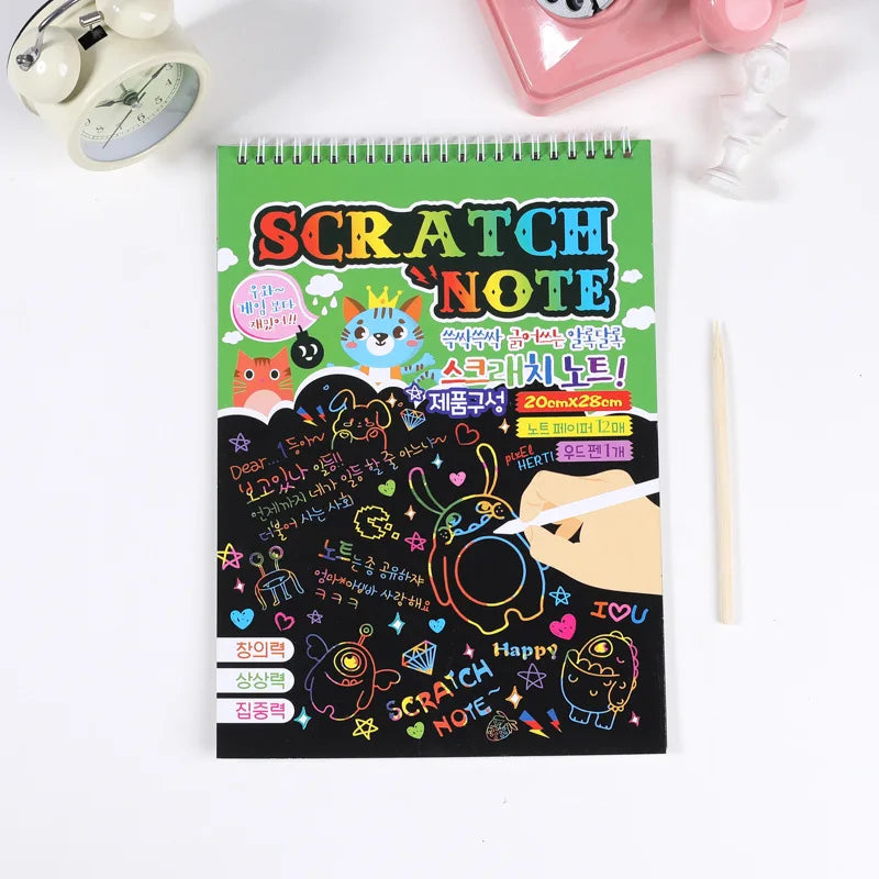 Scratch paper art kit featuring a green cover with colorful designs and text, includes a wooden stylus.
