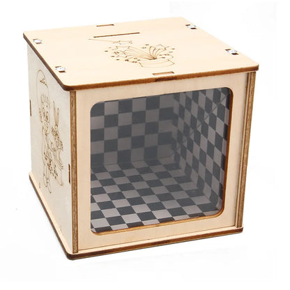 Wooden magic box with a transparent front and checkered interior, featuring cartoon designs on the side.