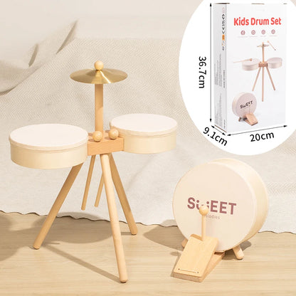 Wooden kids drum set with two white drums, a cymbal, and a pedal, featuring a natural wood finish.