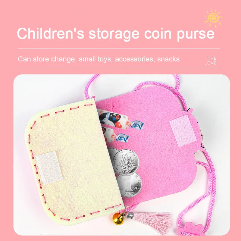Pink and cream children's storage coin purse with coins and cards inside, featuring a tassel and a strap.