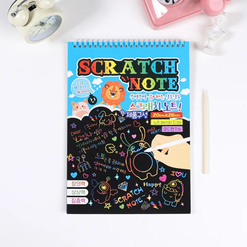 Colorful scratch paper kit with a blue cover, featuring designs and text, includes a pencil and stencils.