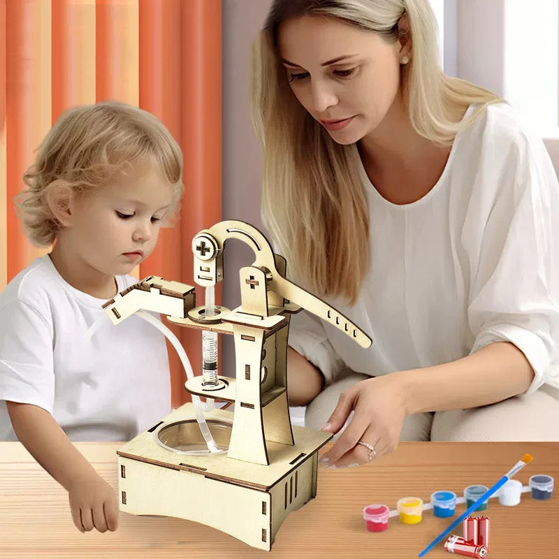 A child and an adult working on a wooden science toy kit with paint pots and a colorful background.