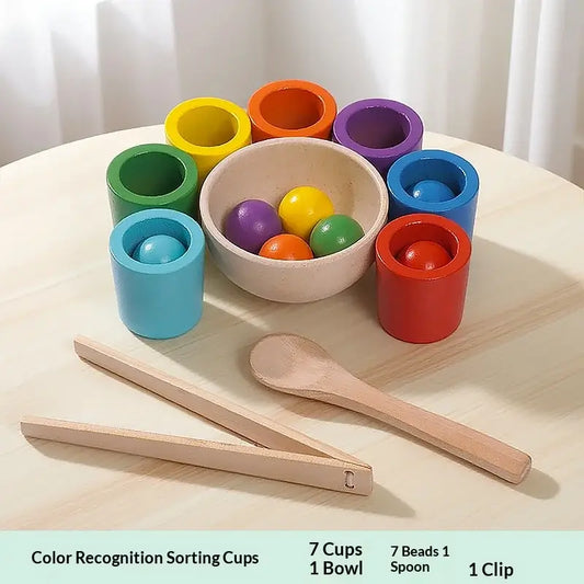 Seven colorful sorting cups in green, blue, yellow, orange, red, and purple, with a bowl of matching beads and wooden