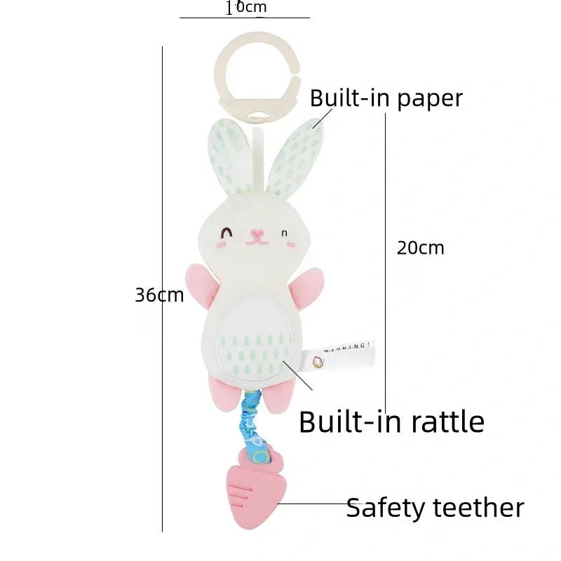 Soft stuffed animal rattle in the shape of a bunny with pink and white colors, featuring a built-in rattle and safety