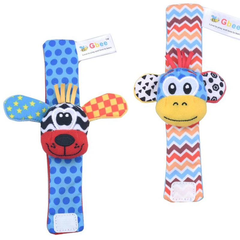 Two colorful baby wrist rattles featuring animal designs, one with a zebra and the other with a monkey, soft fabric.