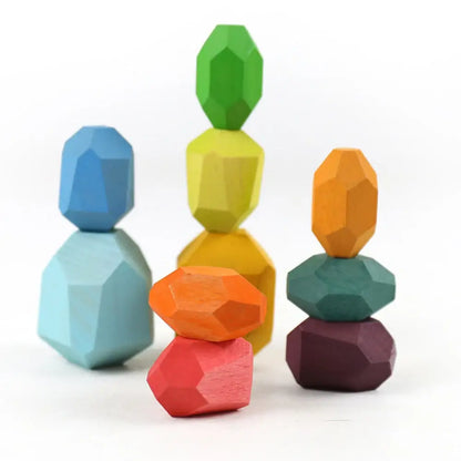 Colorful wooden stacking rocks in various shapes and sizes, including blue, green, yellow, orange, and pink.