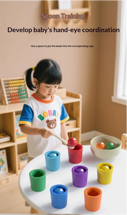 Colorful wooden sorting cups in various colors on a table, with a child using a spoon to match beads.