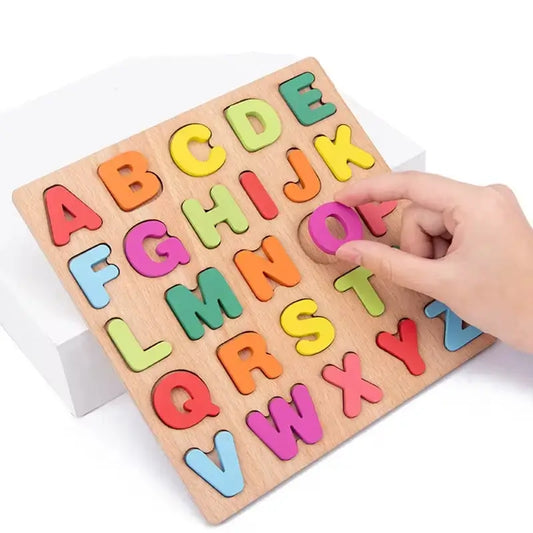Wooden puzzle board featuring colorful uppercase letters A-Z, with a hand placing a pink letter.