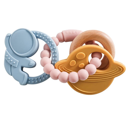 Silicone teether featuring a blue astronaut, pink beads, and a yellow planet ring with wooden accents