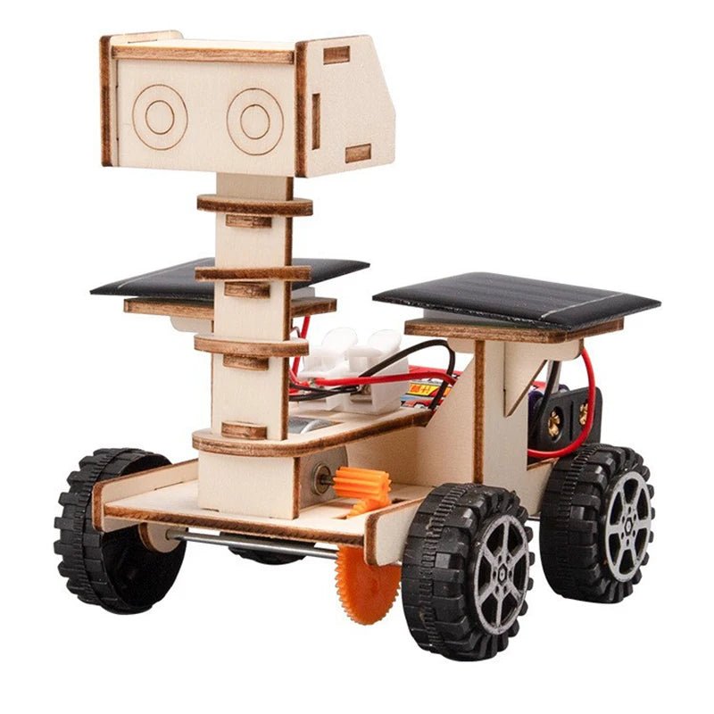 Lunar rover model with wooden body, solar panels, and four black wheels, showcasing a DIY science toy design.