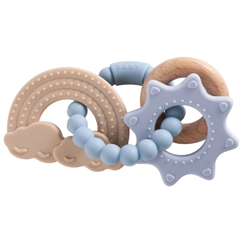 Silicone teether set featuring a rainbow, clouds, and a star shape in soft pastel colors with wooden accents.