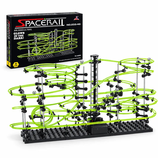 Luminous marble run maze with green rails and black base, featuring an electric elevator, in front of a box.