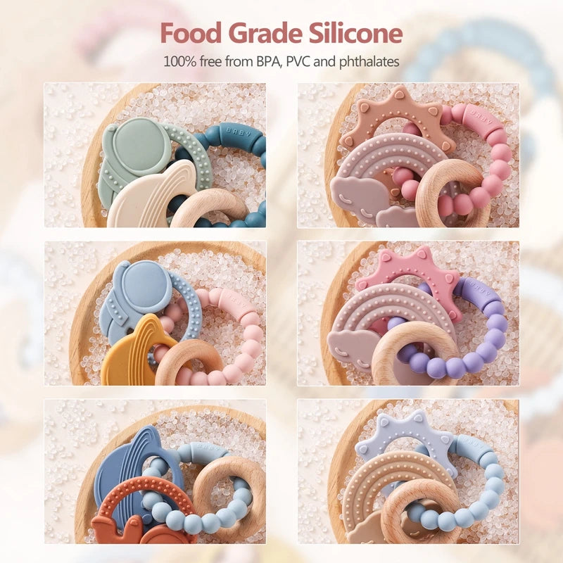 Assorted silicone teething toys in various colors, including rings and shapes, arranged on a light background.