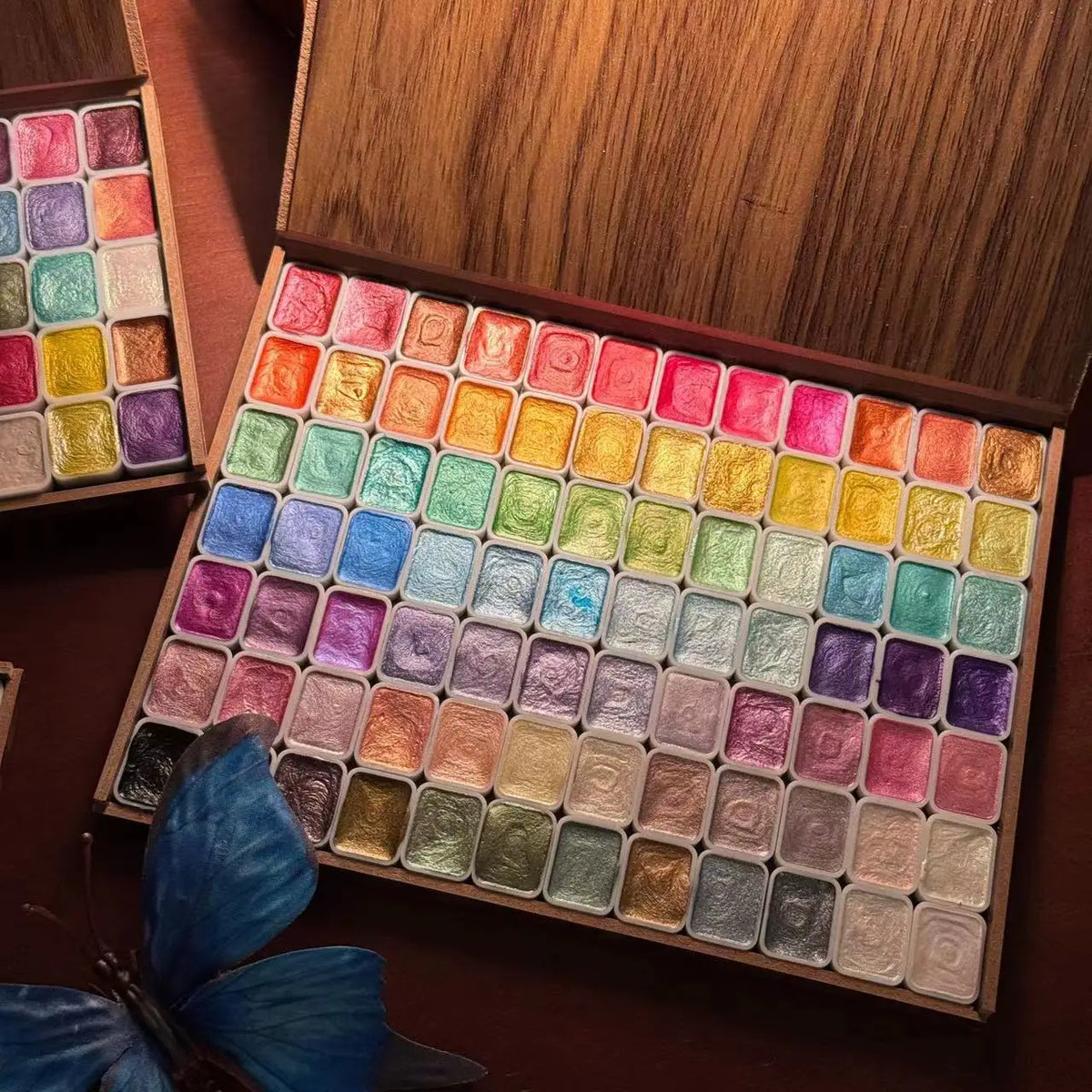 Wooden box containing 120 glitter watercolor paints in vibrant colors arranged in a grid pattern.