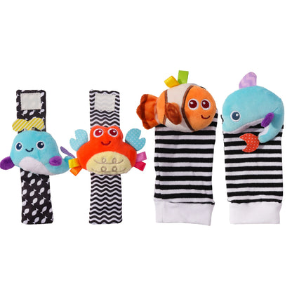 Four colorful baby wrist rattles and socks featuring animal designs, including a crab, fish, and whale with stripes.