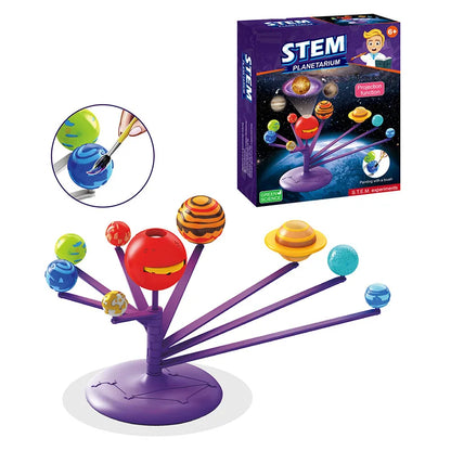 Colorful planetarium model with planets on rods, set against a box featuring educational graphics and instructions.